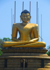 Colombo, Sri Lanka: Gangaramaya Temple - golden Buddha sitting - Slave island - photo by M.Torres