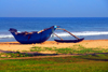 Bentota, Galle District, Southern Province, Sri Lanka: outrigger canoe used by fishermen - beach scene - photo by M.Torres