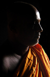 Sri Lanka - Colombo: Sri-Lankan Buddhist Monk in shadow - saffron robe - photo by B.Cain