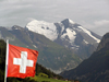 Switzerland - Bernese Alps - Swiss flag against the mountains - Drapeau de la Suisse et montagnes - Flagge der Schweiz - photo by J.Kaman