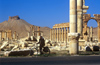 Syria - Palmyra: cycling by the monumental arch (photo by J.Wreford)