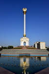 Dushanbe, Tajikistan: Parchan column with the Tajikistani Tajikistani coat of arms reflected on a fountain - National Library on the right - photo by M.Torres