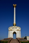 Dushanbe, Tajikistan: the Parchan column, bearing the Tajikistani national emblem / coat of arms - seen against blue sky - photo by M.Torres