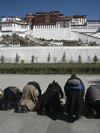 Tibet - Lhasa: Potala Palace - prostrated Buddhist devotees - photo by M.Samper