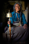 Tibet - Pilgrim spinning prayer wheel - photo by Y.Xu
