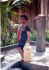 Manatuto: bringing home the water - child with jerrycan