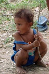 East Timor - Manatuto: toddler hoisting her sandals (photo by M.Sturges)