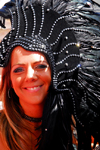 Port of Spain, Trinidad and Tobago: smiling white girl with black feathers on the head during carnival - photo by E.Petitalot