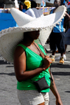 Port of Spain, Trinidad: woman wearing an immense sombrero hat for sun protection - photo by E.Petitalot