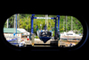 Port of Spain, Trinidad: taking a boat out of the water for repairs - mobile hoist - porthole view - photo by E.Petitalot