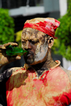 Port of Spain, Trinidad and Tobago: mud covered man drinking beer - carnival parade - Jouvert - photo by E.Petitalot