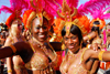 Port of Spain, Trinidad and Tobago: revelers dance in the streets - women with colorful feather crown during carnival - photo by E.Petitalot