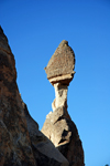 Cappadocia - Greme, Nevsehir province, Central Anatolia, Turkey: fairy chimney near the end - boulder in precarious balance over a thin spire of rock - Valley of the Monks - Pasabagi Valley - photo by W.Allgwer