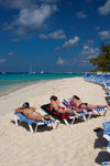 Grand Turk Island, Turks and Caicos: three women sunbathing on southwestern beach - photo by D.Smith