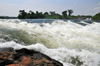 Bujagali Falls, Jinja district, Uganda: fast water flow on a step on the river Nile - seen from the Eastern bank - in 2012 the falls were submerged by the Bujagali Dam - photo by M.Torres