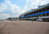 Entebbe, Wakiso District, Uganda: Entebbe International Airport - terminal building with empty air-bridge and executive jet on the apron - photo by M.Torres