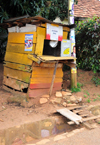 Entebbe, Wakiso District, Uganda: mobile telephone services 'shop' in the developing world, notice the 'pedestrian bridge' - wooden hut - photo by M.Torres