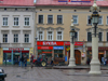 Lviv / Lvov, Ukraine: shops and imposing lamps - city centre - UNESCO World Heritage Site - photo by J.Kaman