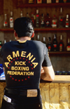 Odessa, Ukraine: young man standing at bar counter, rear view - jeans and t-shirt reading 'Armenia Kick Boxing Federation' - photo by K.Gapys