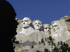 Mount Rushmore National Memorial, Pennington County, South Dakota, USA: statue of sculptor Gutzon Borglum silhouetted against the Mount Rushmore sculptures - photo by C.Lovell