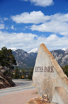 Estes Park, Larimer County, Colorado, USA: town sign on US 36 with the Rocky Mountains peaks as backdrop - schist blade - built to commemorate the 75th Anniversary of the local Rotary Club - photo by M.Torres