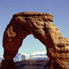 Arches National Park, Utah, USA: La Sal Mountains and Delicate Arch, formed of Entrada Sandstone - photo by J.Fekete