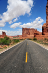Arches National Park, Utah, USA: Courthouse Towers - Tower of Babel and Sheep Rock seen from the road - asphalt and yellow line on Arches Entrance Road - photo by M.Torres