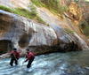 Zion National Park, Utah, USA: Virgin River Narrows - hikers with trekking poles struggle against the current - photo by B.Cain