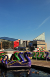 Baltimore, Maryland, USA: colorful dragon paddle boats lined along the Inner Harbor and the National Aquarium - photo by M.Torres