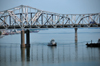 Louisville, Kentucky, USA: boat under the John F. Kennedy Memorial Bridge - cantilever bridge that carries Interstate 65 over the Ohio River, linking Louisville, Kentucky and Jeffersonville, Indiana - photo by M.Torres