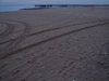 New York City, USA: Coney Island - beach at dusk - pier and tire marks on the sand - photo by M.Bergsma