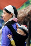 Ba Be National Park - vietnam: woman with baby - the white headscarf tells that her husband is gone recently - photo by Tran Thai