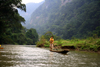 Ba Be National Park - vietnam: river scene - man on a long dug-out canoe - photo by Tran Thai