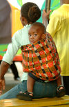 Zambia - Livingstone: waiting for a bus - curious toddler on his mother's back - photo by J.Banks