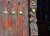 Stone Town, Zanzibar, Tanzania: decorative carved wooden door with brass knobs - metal studs - International Business Services, below Forodhani Orphanage - Mizingani road - photo by M.Torres
