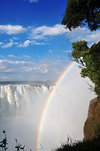 Victoria Falls, Matabeleland North, Zimbabwe: Victoria Falls aka Mosi-oa-Tunya - rainbow and spray - long known by the Portuguese, but made famous by Scottish missionary David Livingstone - Victoria Falls National Park - UNESCO World Heritage Site - photo by M.Torres