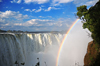Victoria Falls, Matabeleland North, Zimbabwe: Victoria Falls aka Mosi-oa-Tunya - the Zambezi river drops from the basalt plateau - rainbow and spray - Victoria Falls National Park - UNESCO World Heritage Site - photo by M.Torres